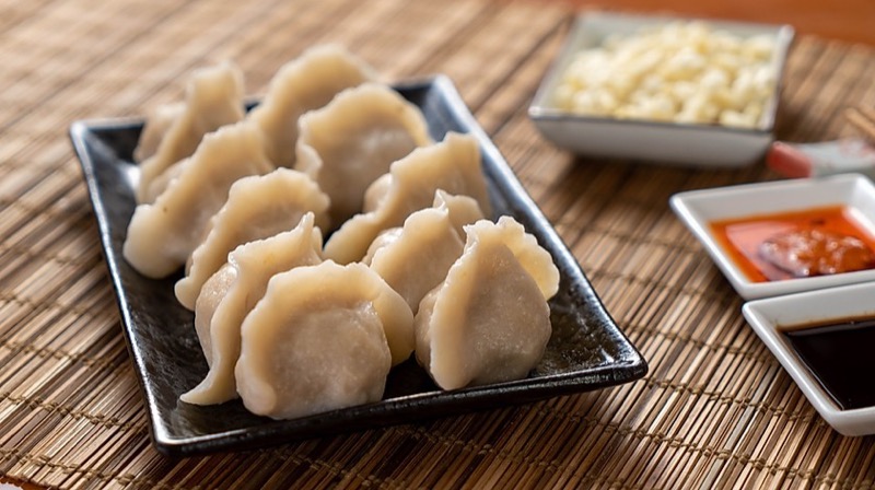 Boiled dumplings neatly arranged with garlic and chili sauce