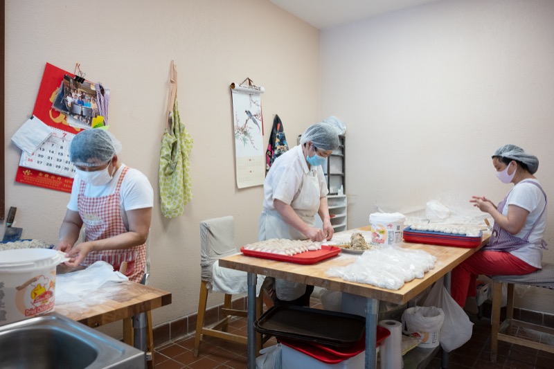 Kitchen team working together to make dumplings